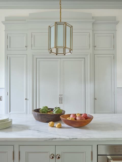Classic French Gray Cabinetry with Marble Countertops - best blue kitchens