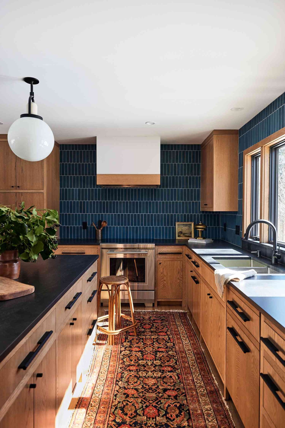 Warm Wood and Deep Teal Kitchen with Subway Tile Backsplash - best blue kitchens